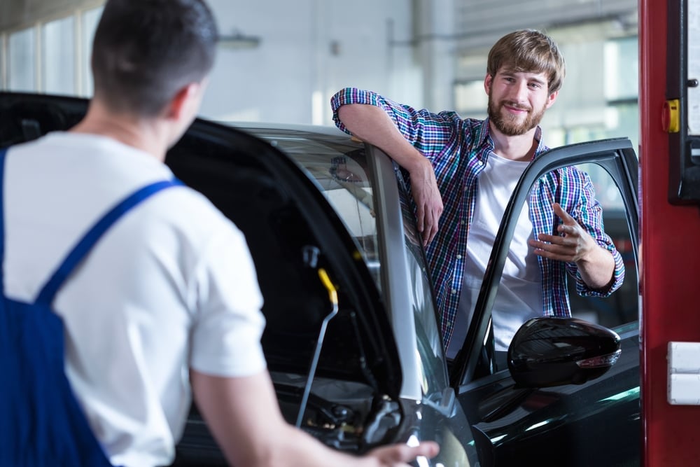 Photo of content male customer of car service station